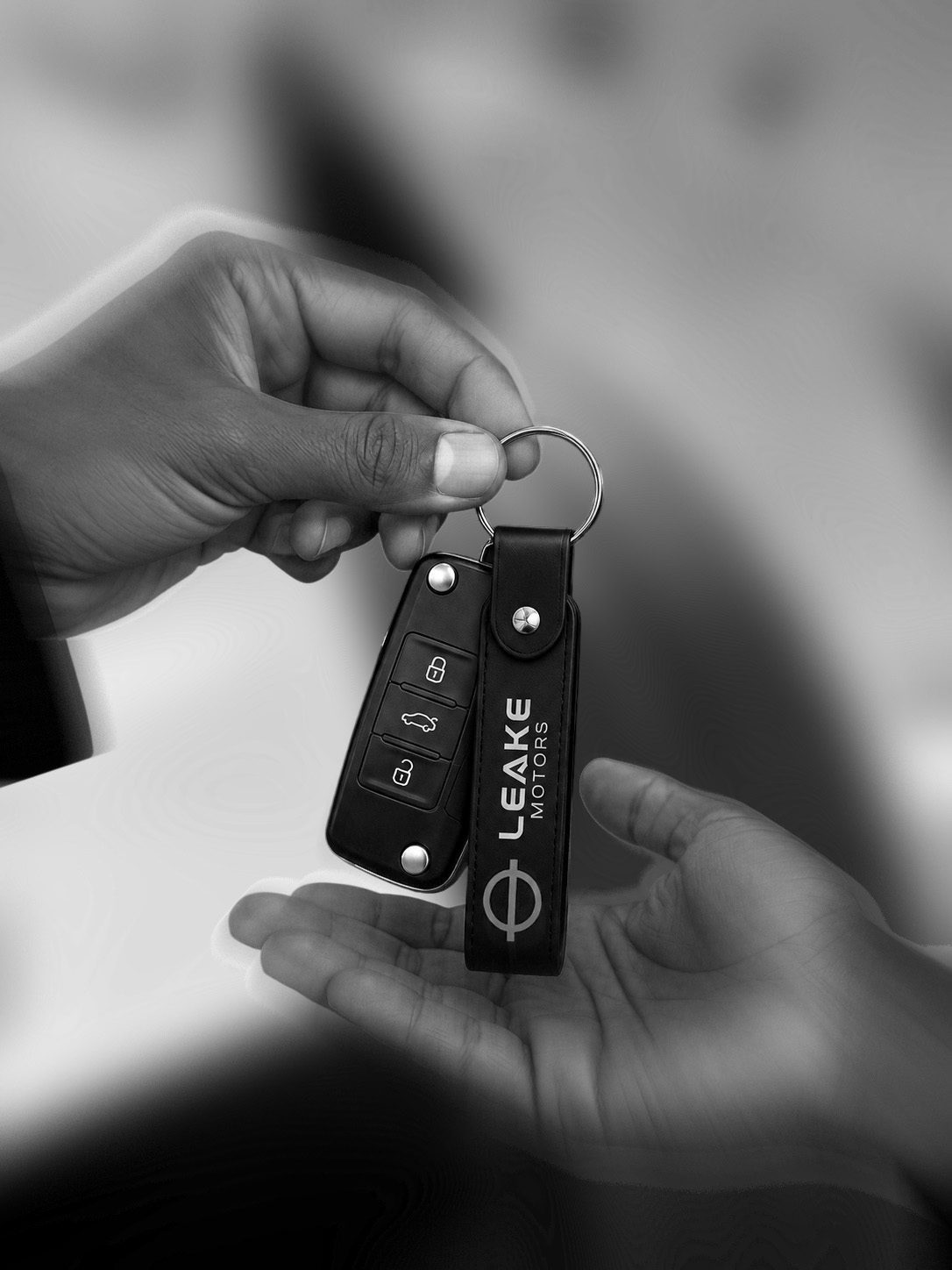 Car keys with a Leake Motors key tag being handed over
